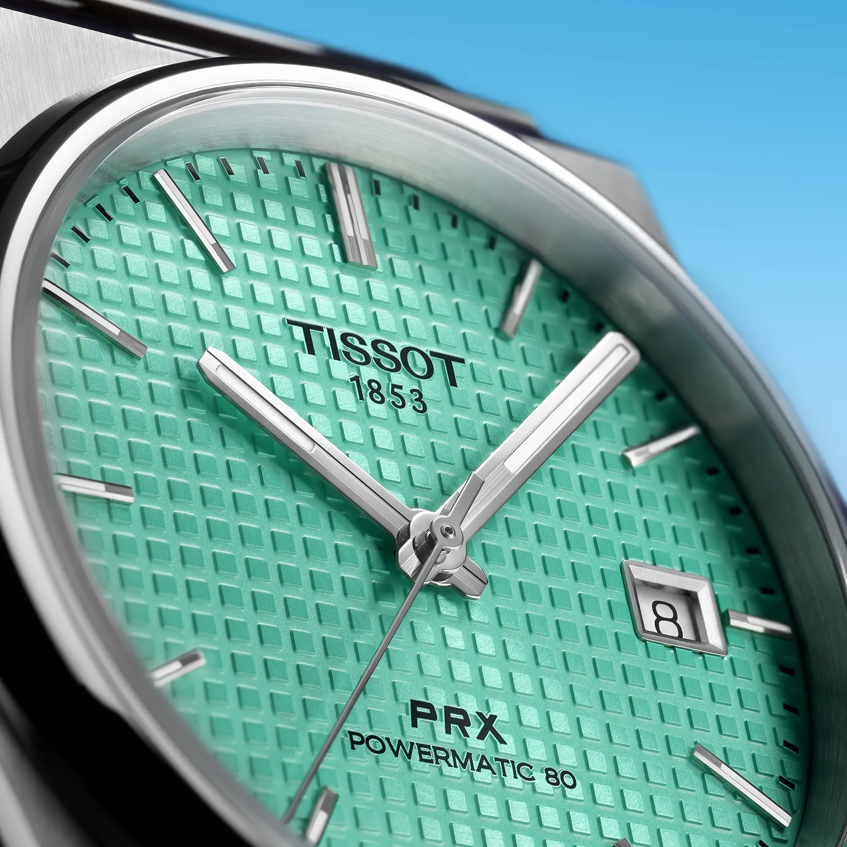 Tissot PRX Powermatic 80 40mm watch on a colored background