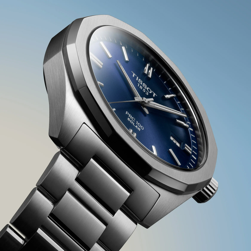 Tissot PRC 100 Solar Quartz 39mm watch on a colored background