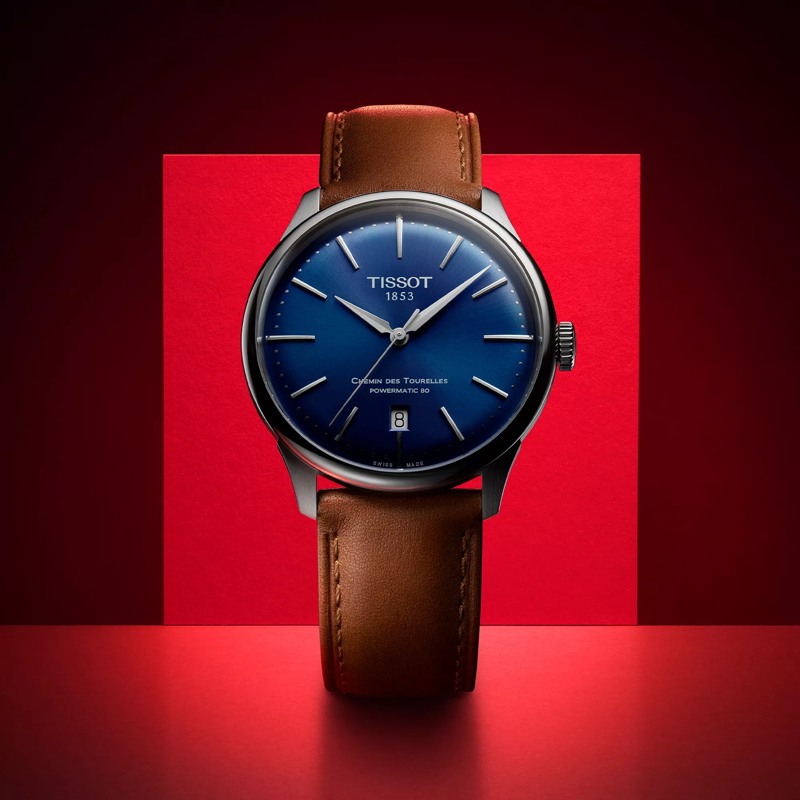 Tissot Chemin des Tourelles Powermatic 80 42 mm watch on a colored background