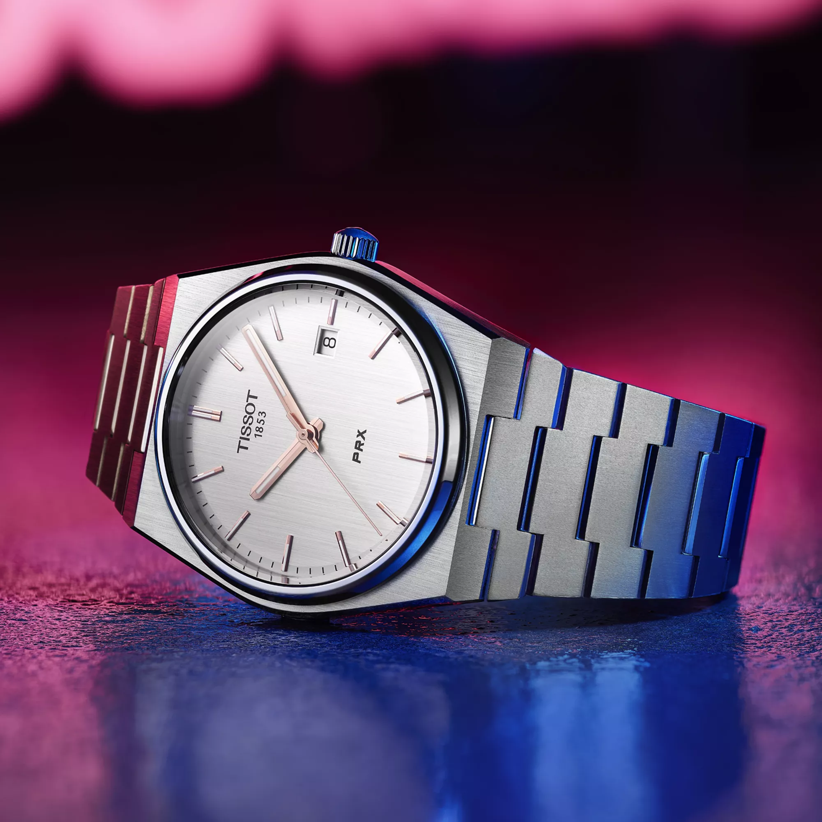 Tissot PRX 40mm watch on a colored background