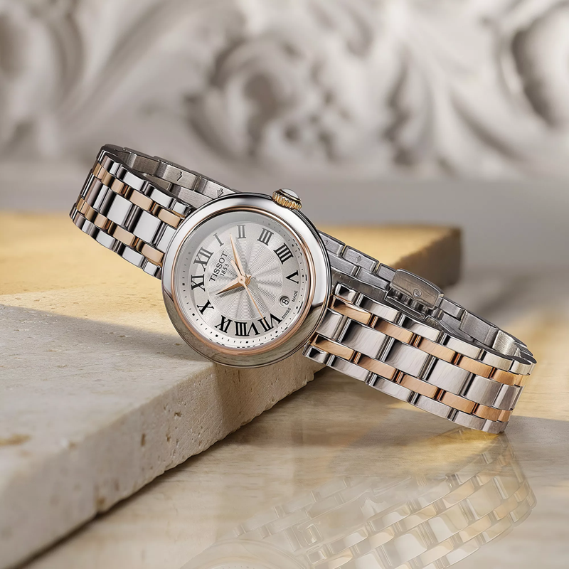 Tissot Bellissima Small Lady watch on a colored background