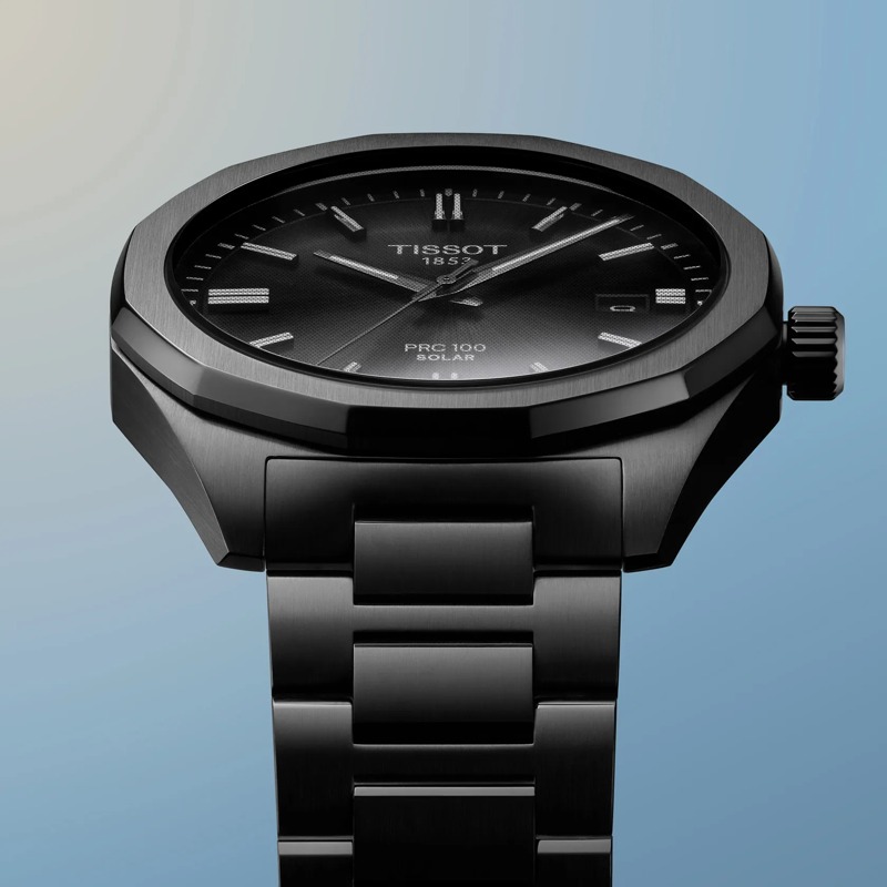 Tissot PRC 100 Solar Quartz 39mm watch on a colored background