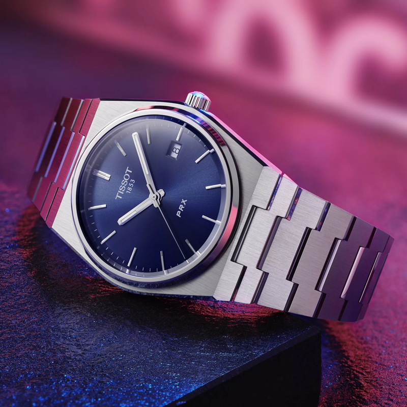 Tissot PRX 40mm watch on a colored background