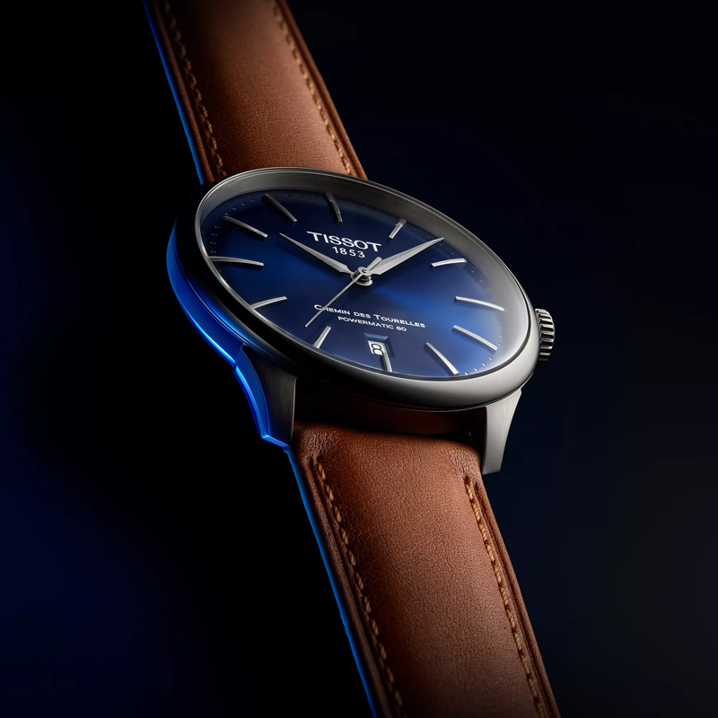 Tissot Chemin des Tourelles Powermatic 80 42 mm watch on a colored background