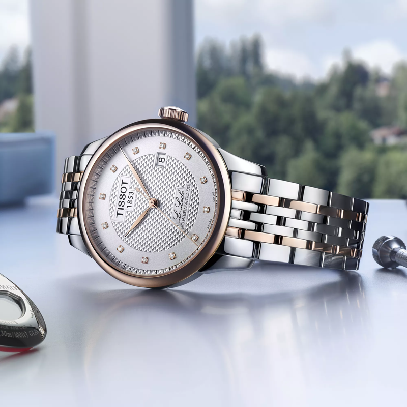 Tissot Le Locle Powermatic 80 watch on a colored background
