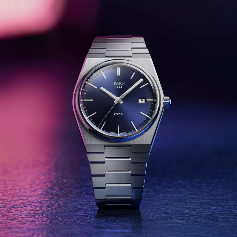 Tissot PRX 40mm watch on a colored background